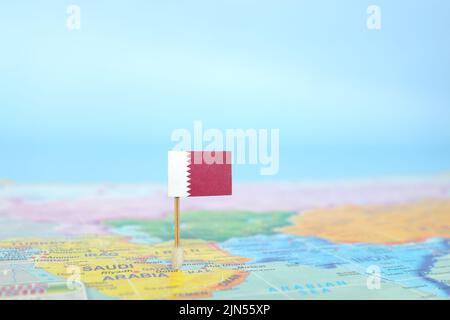 Selective focus of Qatar flag in world map. Qatar country location and sovereignty concept. Stock Photo