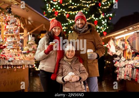 family with takeaway drinks at christmas market Stock Photo