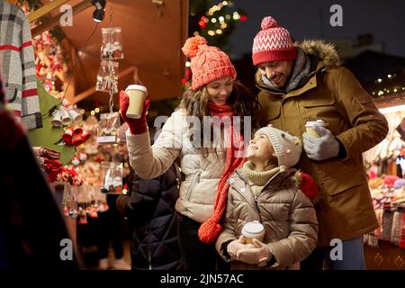 family with takeaway drinks at christmas market Stock Photo