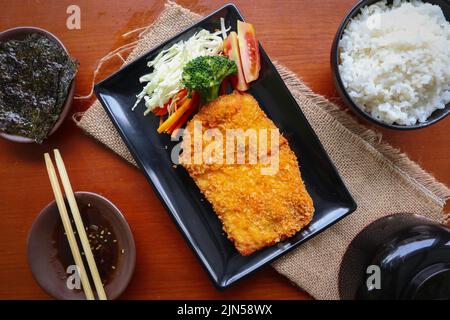 chicken katsu don is japanese food served with soy sauce on table Stock Photo