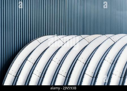 Industrial building facade made of corrugated steel metal sheets as background and texture, copy space included Stock Photo