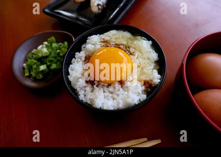 tamago kake gohan or raw egg on rice. traditional food from japan, eat on breakfast Stock Photo