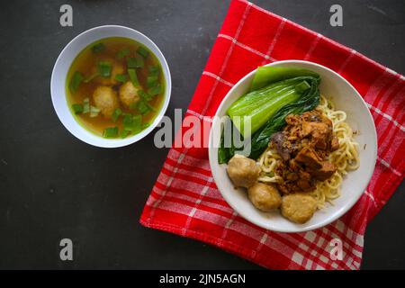 mie ayam or noodles chicken is traditional food from indonesia, asia made from noodle, chicken, chicken broth, spinach, sometimes with meatball. Stock Photo