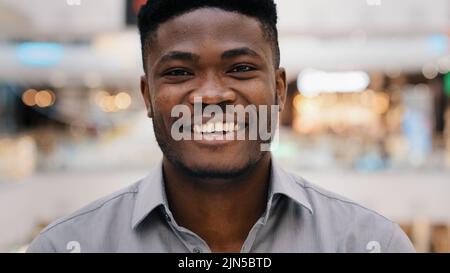 Male portrait close-up young surprised amazed african american man feeling shock surprise happy guy smiling nodding answers yes positive answer great Stock Photo