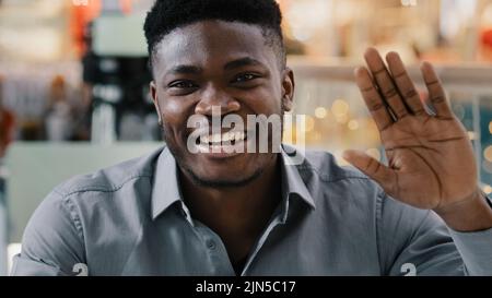 Close-up happy joyful african american man looking at camera talking on video call smiling recording video blog cheerful male mentor coach leading Stock Photo