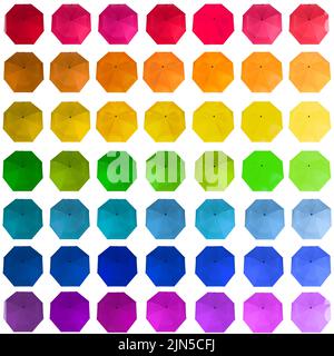 Big of rainbow colors umbrellas isolated on white background. Top view. Stock Photo