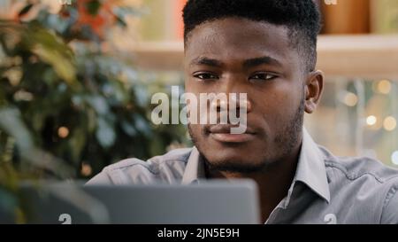 Close-up pensive confident manager freelancer working on laptop writes report thinks about solving problem startup new idea focused deep in thought Stock Photo