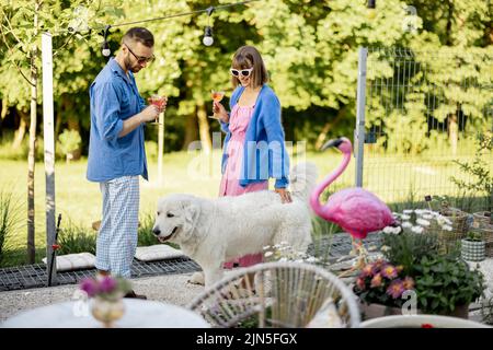 Stylish couple spend summer time at the backyard Stock Photo