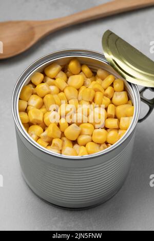 Open tin can with preserved corn  close up Stock Photo