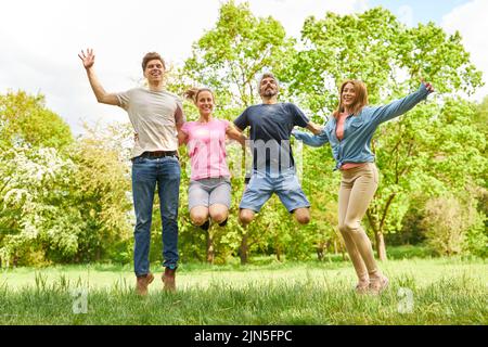 Group of young people have fun jumping in the air for joie de vivre and lightness Stock Photo