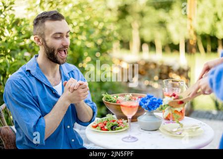 Young family having lunch at backyard on summer Stock Photo