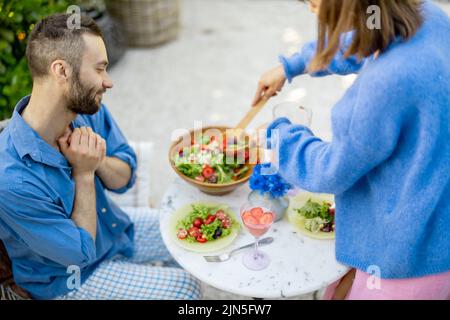 Young family having lunch at backyard on summer Stock Photo