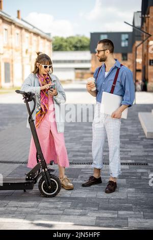 Stylish colleagues meet together outdoors Stock Photo