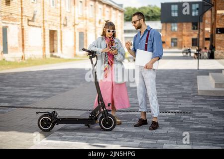 Stylish colleagues meet together outdoors Stock Photo