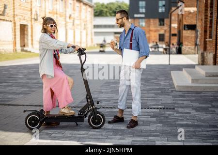 Stylish colleagues meet together outdoors Stock Photo