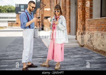 Young hipsters hang out together near office outdoors Stock Photo