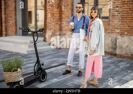 Stylish colleagues meet together outdoors Stock Photo
