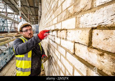 Construction workers in action on construction site Stock Photo