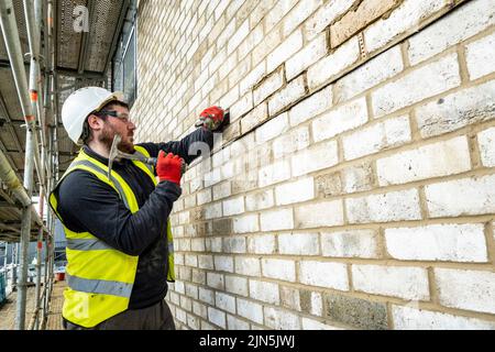 Construction workers in action on construction site Stock Photo