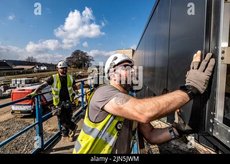 Construction workers in action on construction site Stock Photo
