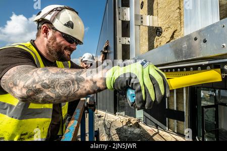 Construction workers in action on construction site Stock Photo