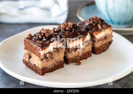 Chocolate tartlet. Small chocolate cake in a plate. On dark floor. close up Stock Photo