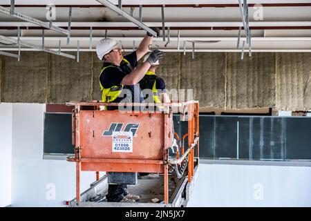 Construction workers in action on construction site Stock Photo