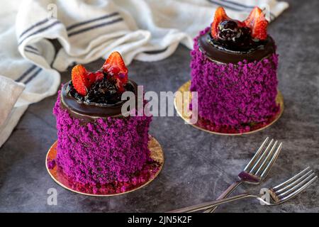 Fruitcake. Cake prepared with forest fruits on a dark background. close up Stock Photo