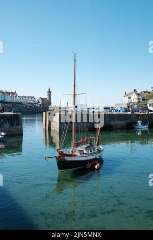 A beautiful ketch leaves Porthleven harbour Stock Photo