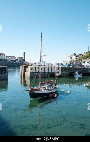 A beautiful ketch leaves Porthleven harbour Stock Photo