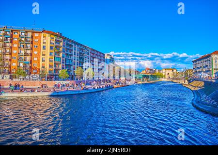 MILAN, ITALY - APRIL 9, 2022: Darsena di Milano, the popular tourist spot with restaurants, bars and wide pedestrian embankment, on April 9 in Milan Stock Photo