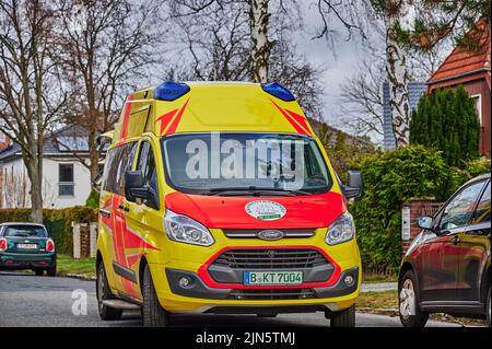 Berlin, Germany - February 7, 2022: Ambulance in action on a side street in Berlin. Stock Photo