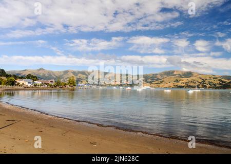 Akaroa bay is a former French settlement in the small town of Akaroa on the Banks Peninsula on the South Island of New Zealand. Stock Photo