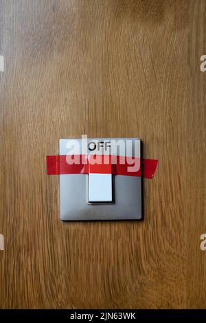 a switch stuck with red tape in the off position Stock Photo