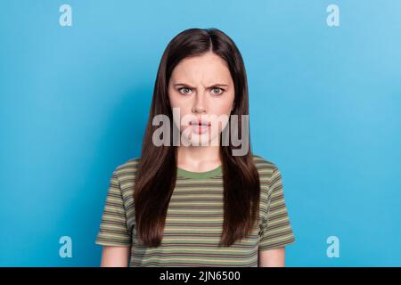 Photo of sad millennial brunette lady wear green t-shirt isolated on blue color background Stock Photo