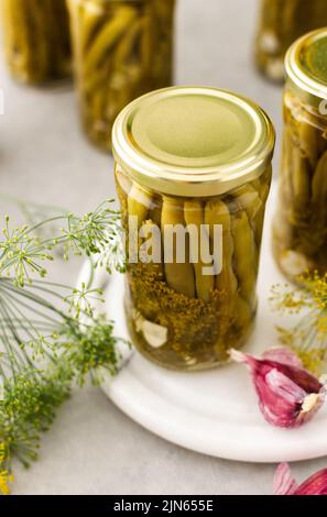 Preparing for autumn and winter, canned asparagus beans in jars, pickled or fermented vegetables Stock Photo