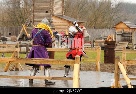 Men reenactors in metal armor of an Old Rus knights reconstructing ...