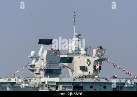 View of the Royal Navy aircraft carrier HMS Queen Elizabeth dressed overall - April 2022. Stock Photo