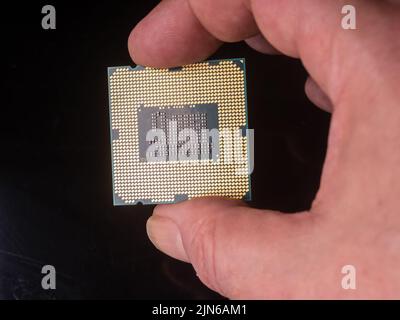 Human Hand Holding A Computer Chip / CPU Stock Photo