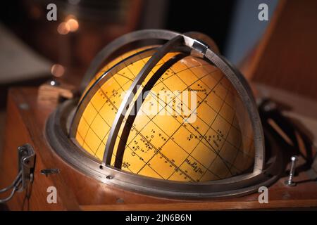 Old travel star sky globe in wooden box, vintage marine navigation equipment Stock Photo