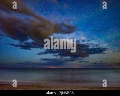 Stars and clouds in night sky over Lake Michigan from Door County Wisconsin Stock Photo