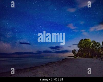 Stars and clouds in night sky over Lake Michigan from Door County Wisconsin Stock Photo