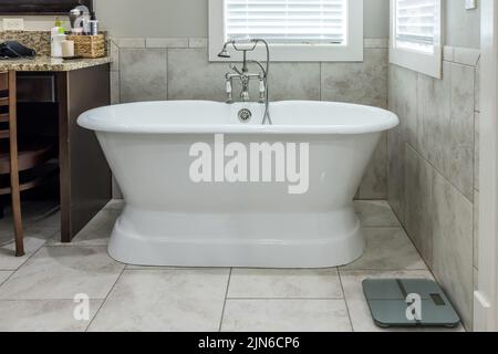 Master bathroom freestanding bathtub in a tiled master bathroom Stock Photo