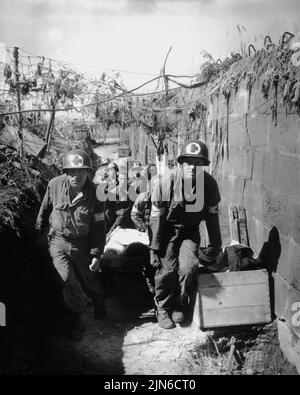 NEAR BREST, FRANCE - 28 August 1944 - US Army medics remove a casualty from the battle field to an aid station in an air raid shelter, near Brest, Fra Stock Photo