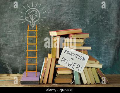 Learning,knowledge,education or back to school concept with books, education is power sign, lightbulb, idea symbol and ladder of success.Free copy spa Stock Photo