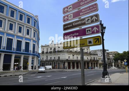 Landscape with scenic view of the iconic Telégrafo Axel Hotel and several city street signs on the corner of Paseo José Martí  in Havana, Cuba. Stock Photo