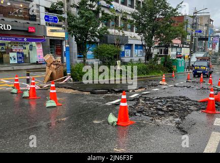 Seoul, South Korea. 9th Aug, 2022. Photo taken with a mobile phone shows a road damaged by heavy rains in Seoul, South Korea, Aug. 9, 2022. Eight people were killed and six others went missing as South Korea's metropolitan region was pounded by heavy rains, the Central Disaster and Safety Countermeasures Headquarters said Tuesday. Over 100 millimeters per hour of rains hit the capital Seoul, the western port city of Incheon and Gyeonggi province, which surrounds Seoul, on Monday night. Credit: Wang Yiliang/Xinhua/Alamy Live News Stock Photo