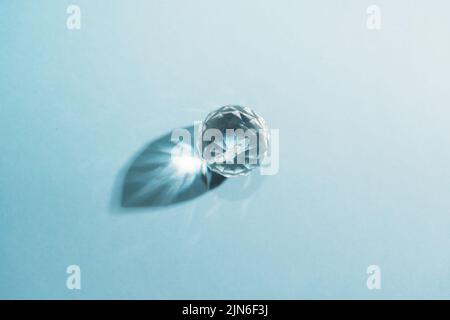 One sphere crystals with light refraction on blue minimal background  Stock Photo