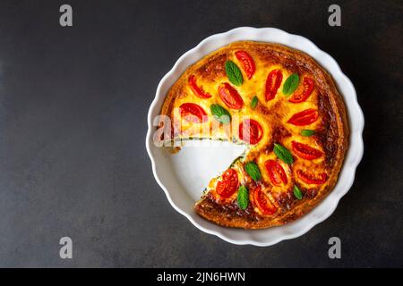 Vegetarian homemade pie, Quiche with tomatoes, spinach and feta cheese, spinach quiche (Turkish name; ispanakli kis) Stock Photo