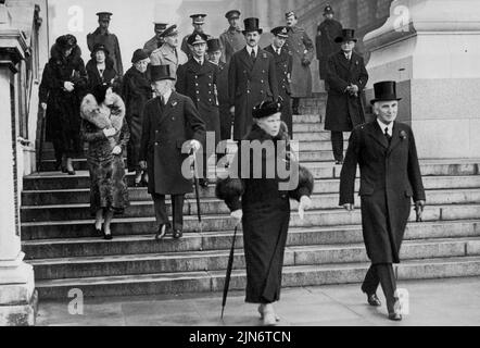 Armistice Day In London -- H.M. the Queen leaving the Home Office with Sir John Simon after watching the ceremony at the Cenotaph. Group at back includes the Duke and Duchess of York, the Duke of Kent, Prince Arthur of Connaught, Princess Helena Victoria and Princess Marie Louise. November 11, 1935. (Photo by The International Graphic Press Ltd.). Stock Photo